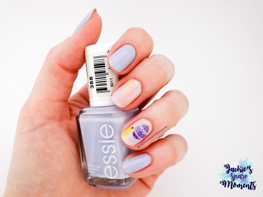 Finished Easter manicure 2018 holding Essie Virgin Snow