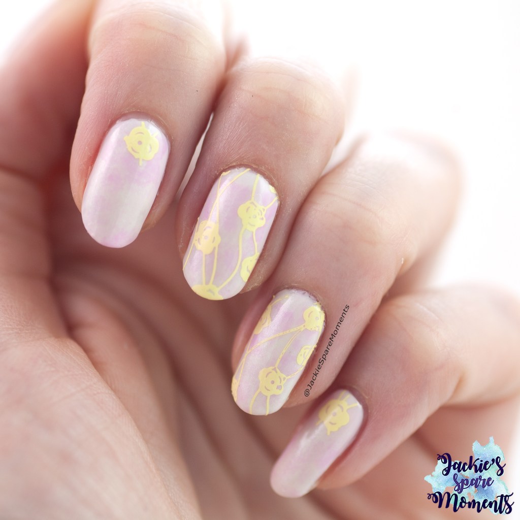 Pastel nail art with floral stamping