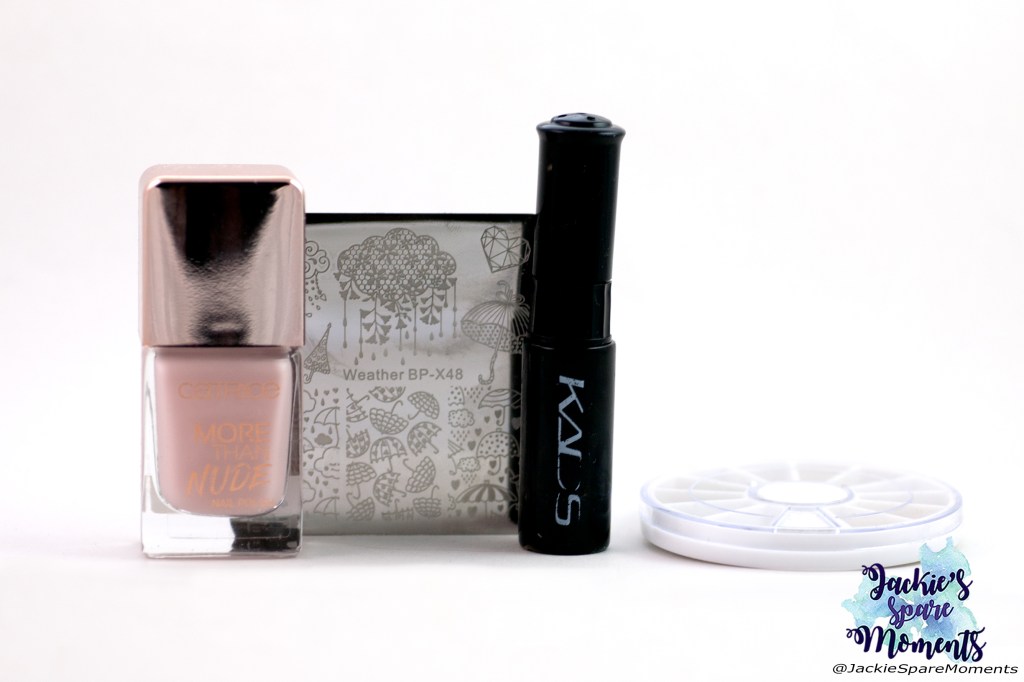 Materials used for black negative space nail art: Catrice More Than Nude 06 Roses are Rosy, KADS black stamping polish, BornPretty stamping plate Weather BP-X48, assorted studs.