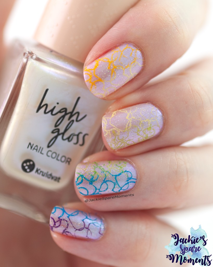 Pride nail art. Base is Kruidvat 012 chrome moon. Rainbow stamped heart image. Topped with China Glaze Fairy Dust