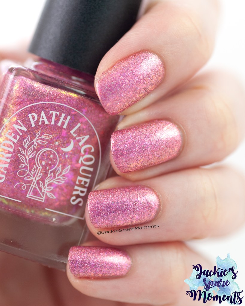 Pink nail polish with flakes and glitter